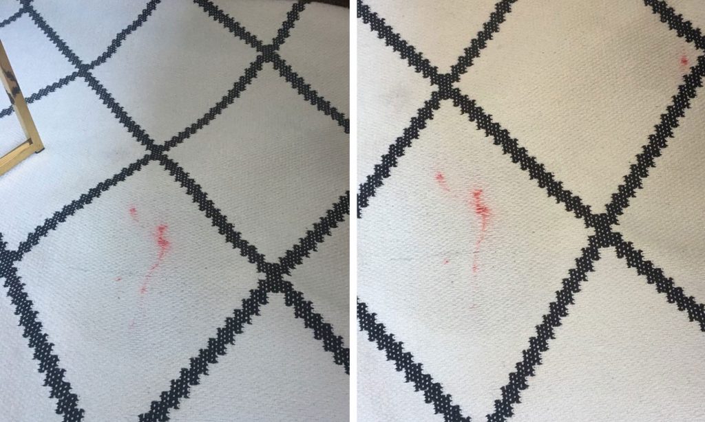 Roter Nagellackfleck auf weißem Teppich